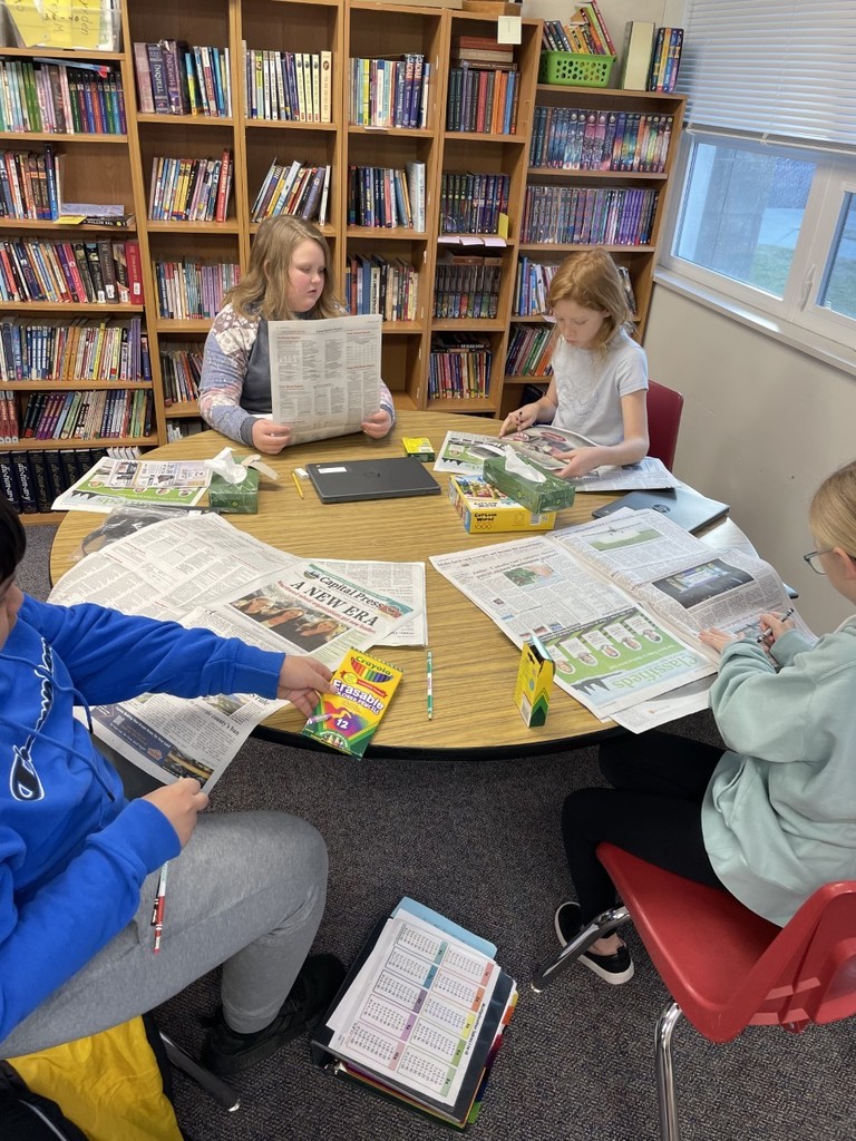 4th and 5th graders studying elements of a newspaper